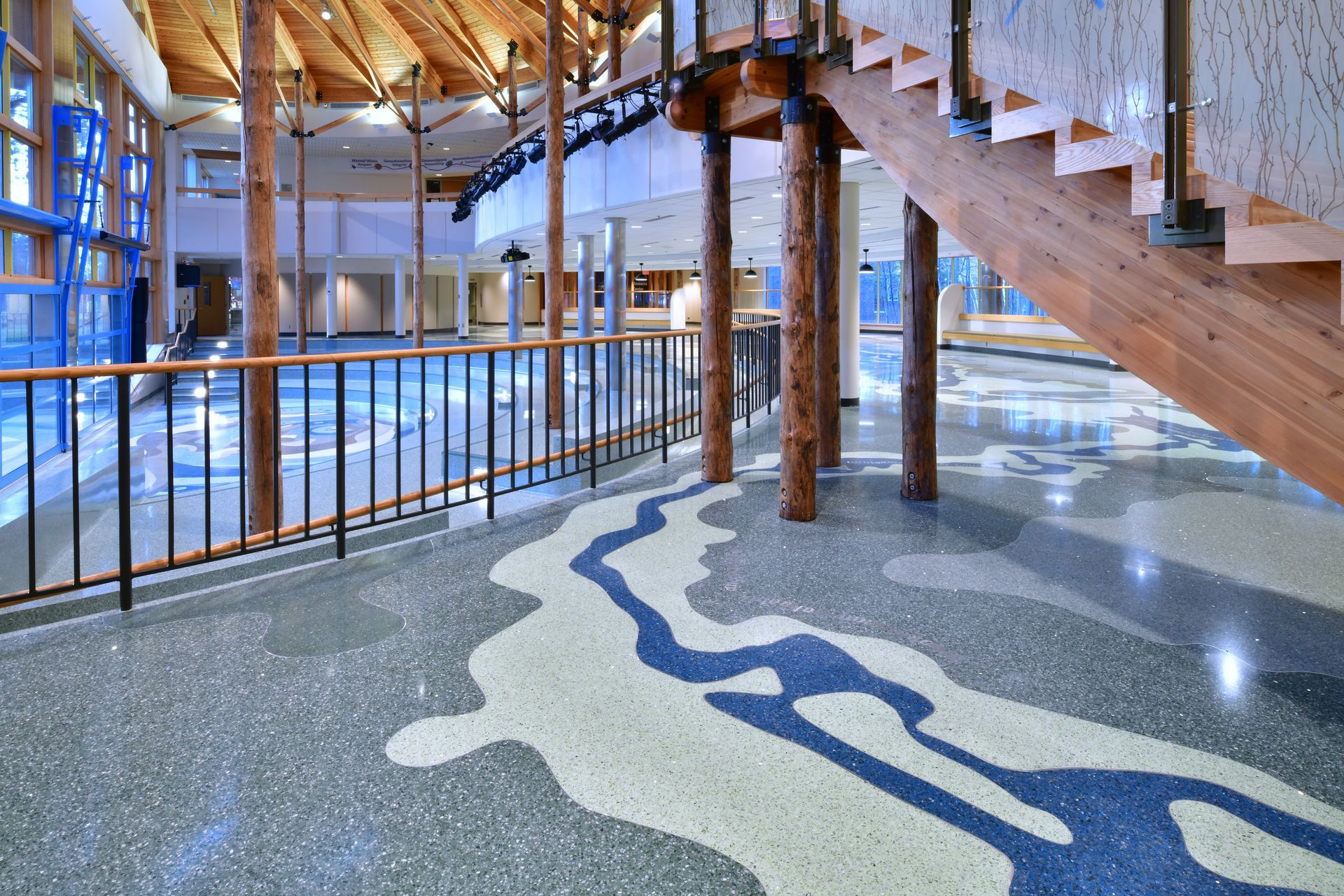 A staircase in a building with a river pattern on the floor