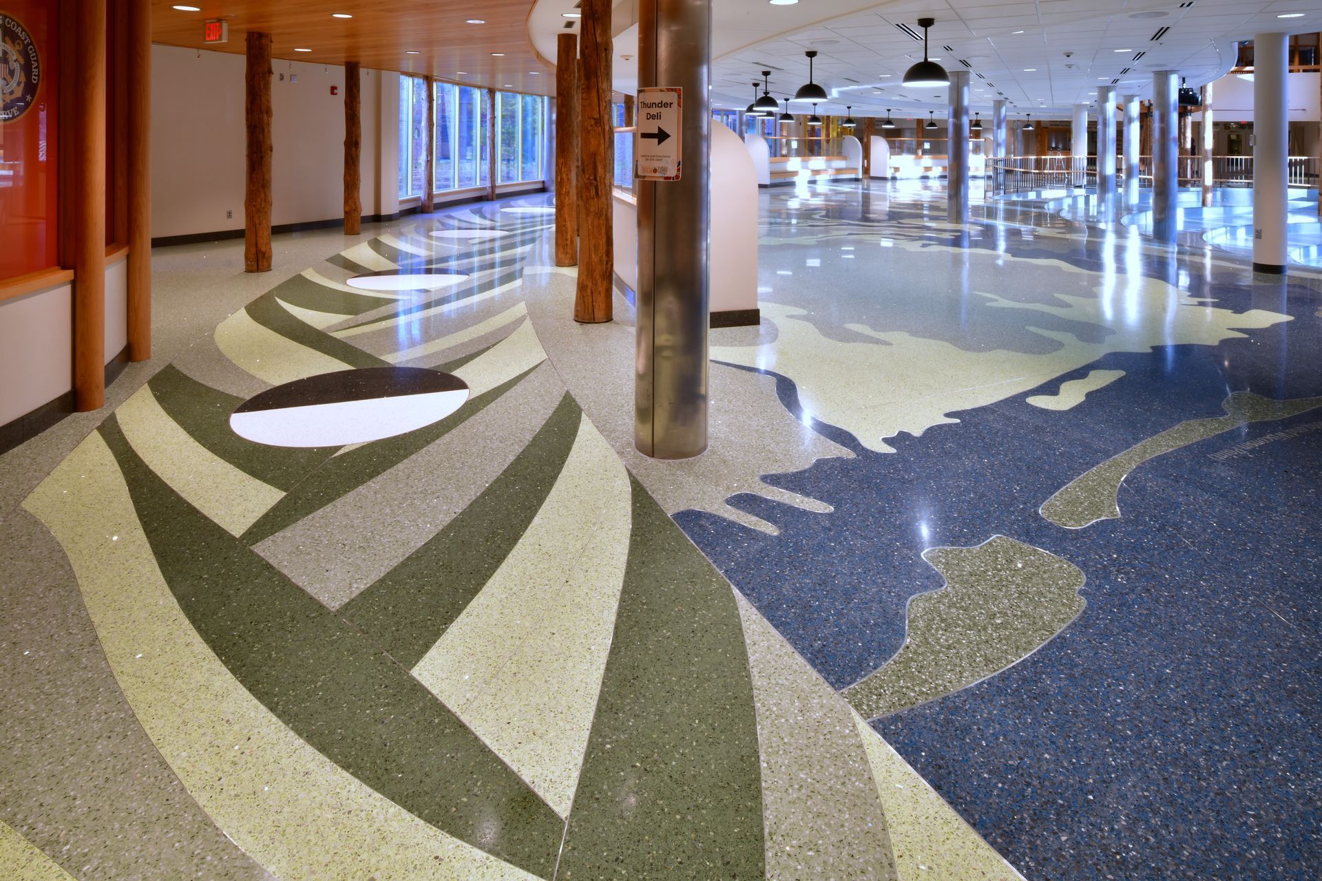 A large hallway with a map of the world on the floor