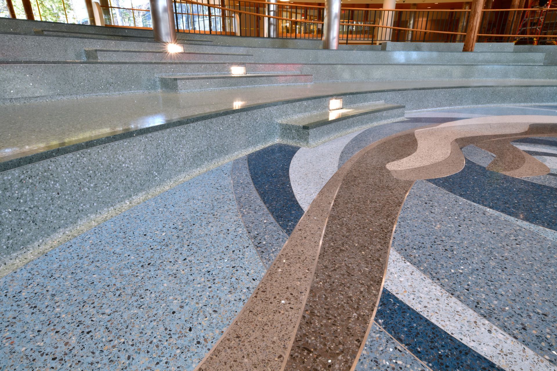 A staircase with a circular pattern on the floor