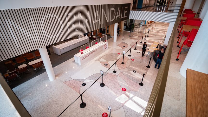 An aerial view of the lobby of a building with people standing in line.