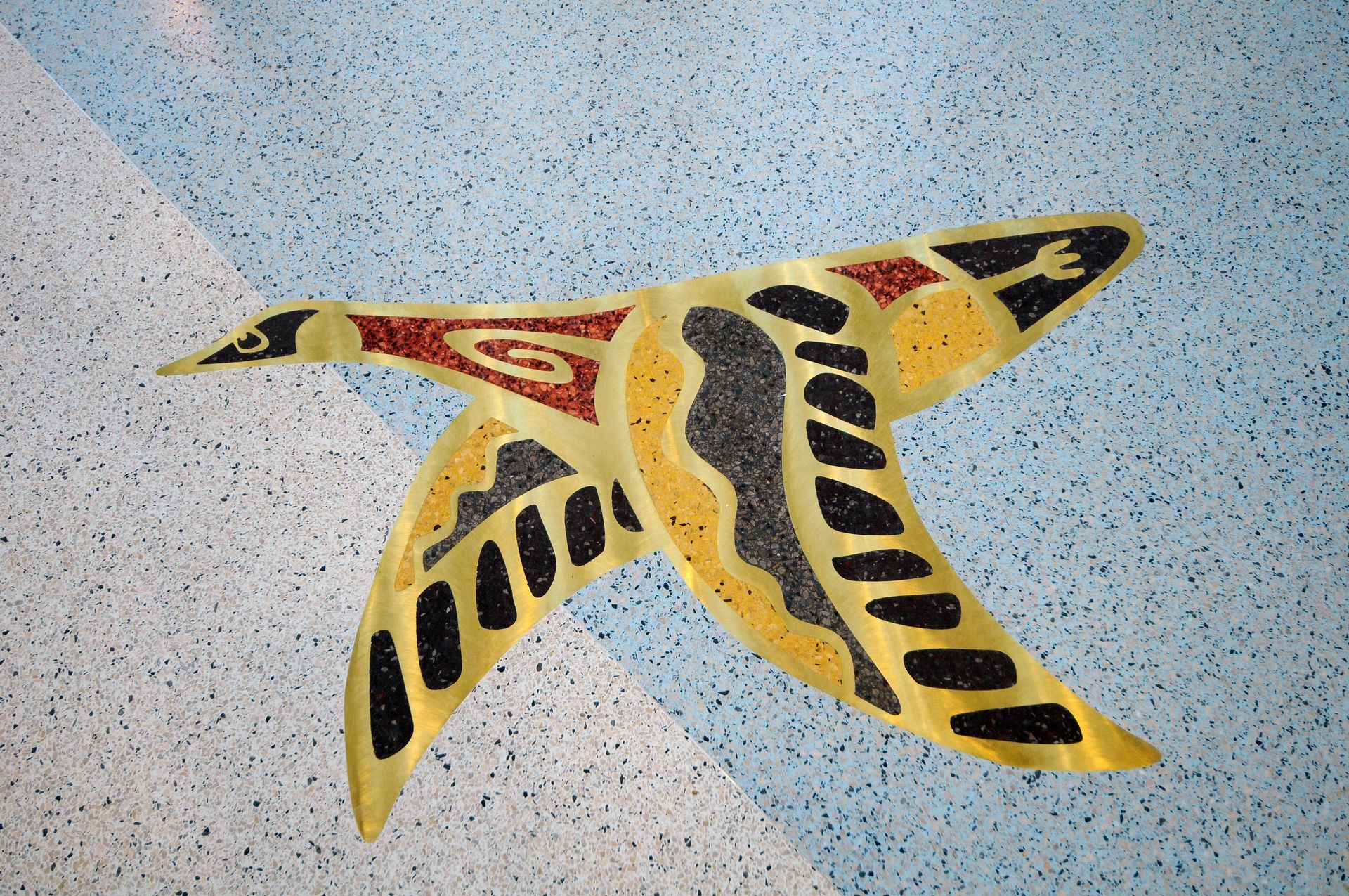 A painting of a bird on a blue and white tile floor