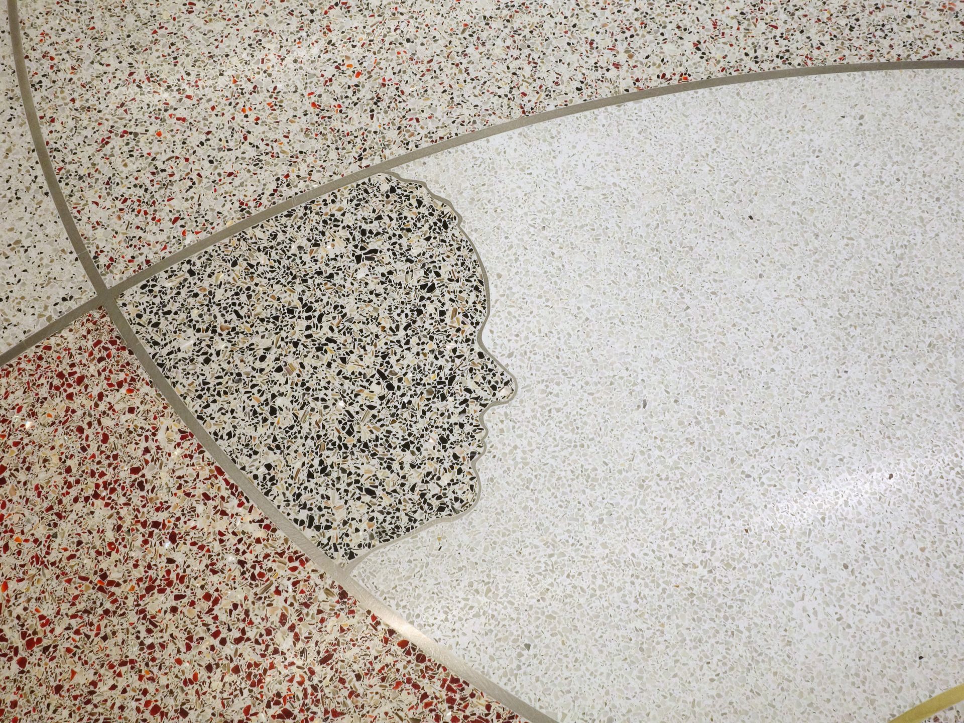 A close up of a tiled floor with a silhouette of a face on it.