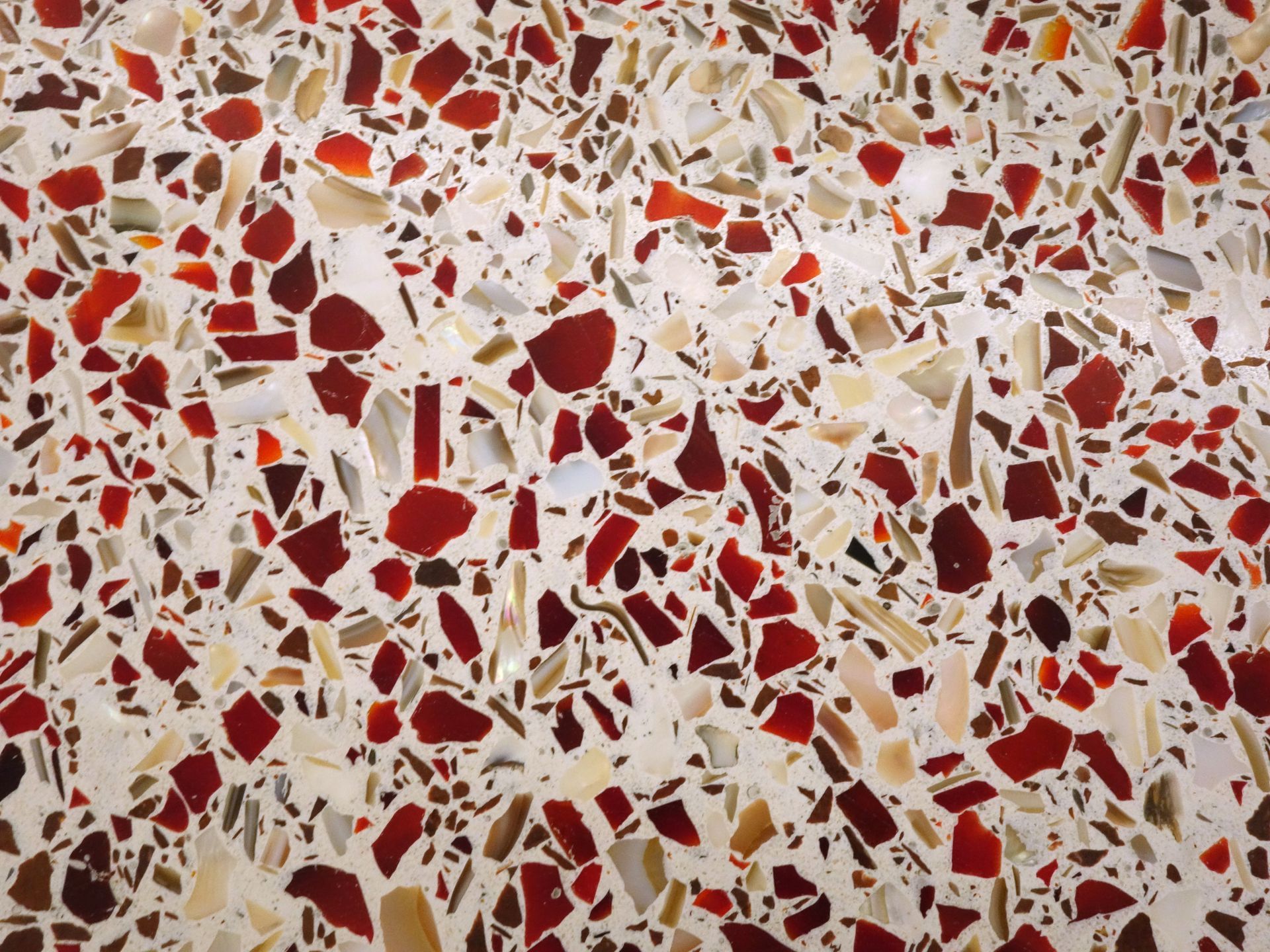 A close up of a red and white terrazzo floor