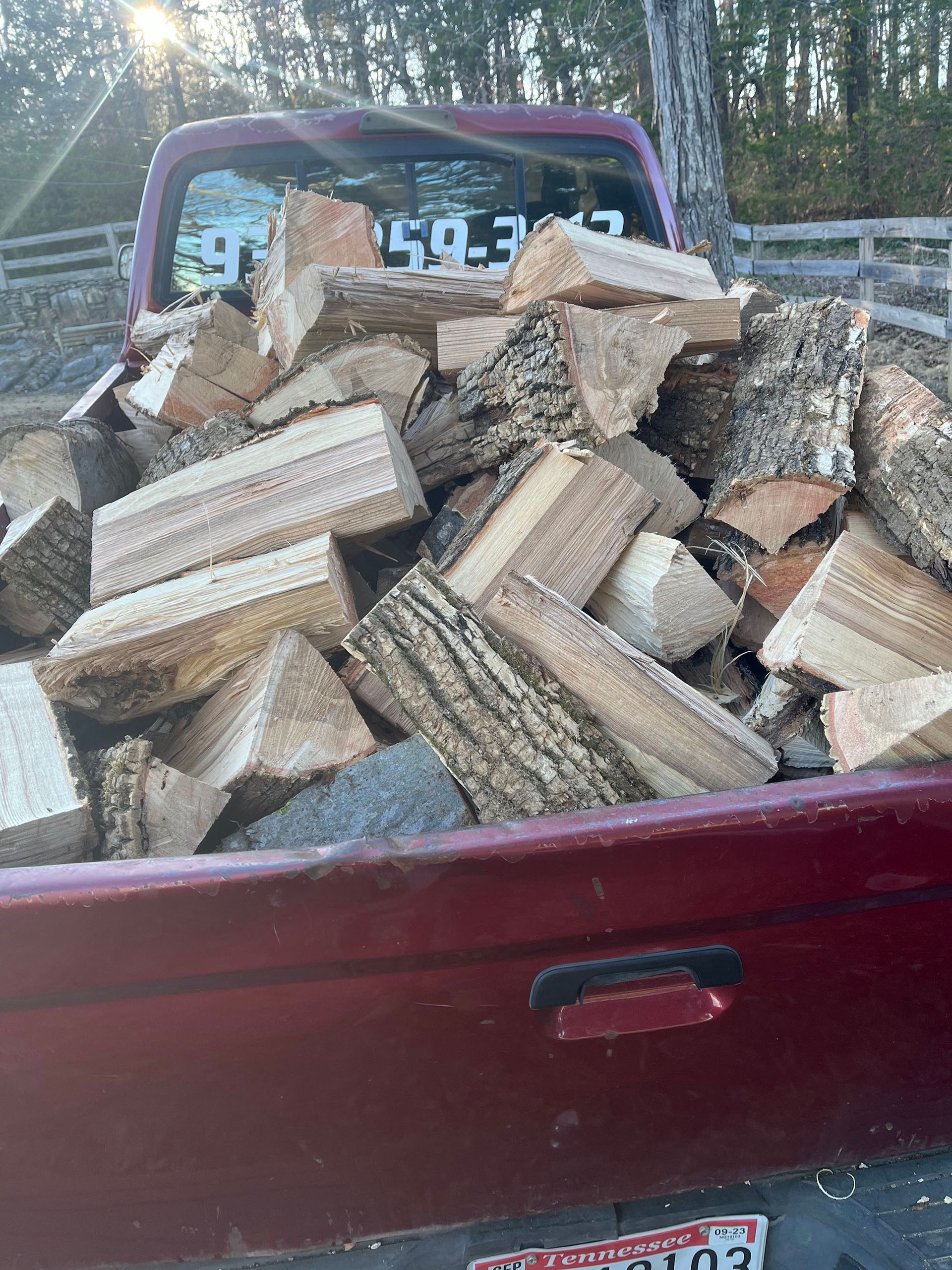 A pile of wood is in the back of a truck.