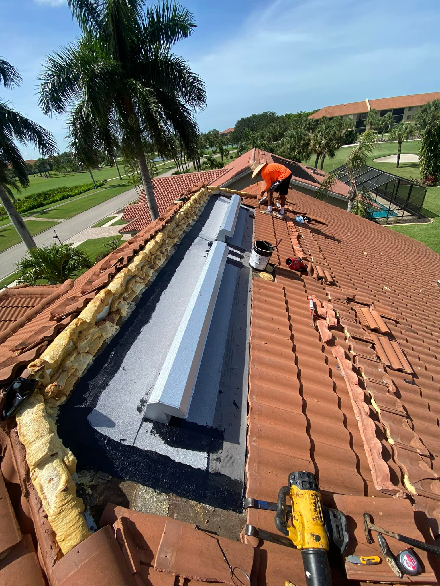 A man is working on the roof of a house.