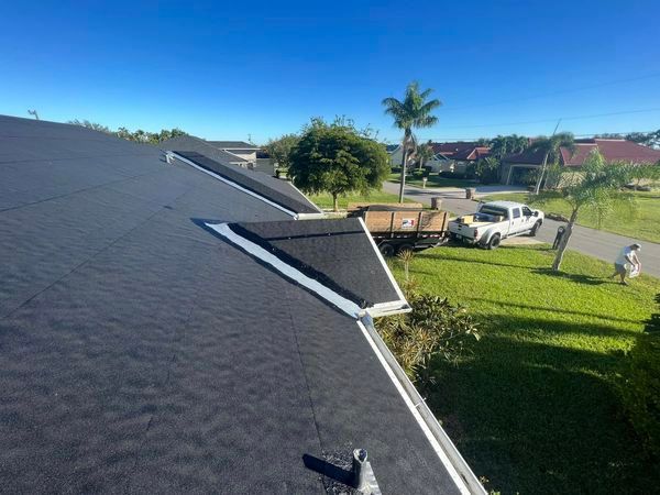 A truck is parked on the side of the road next to a roof.