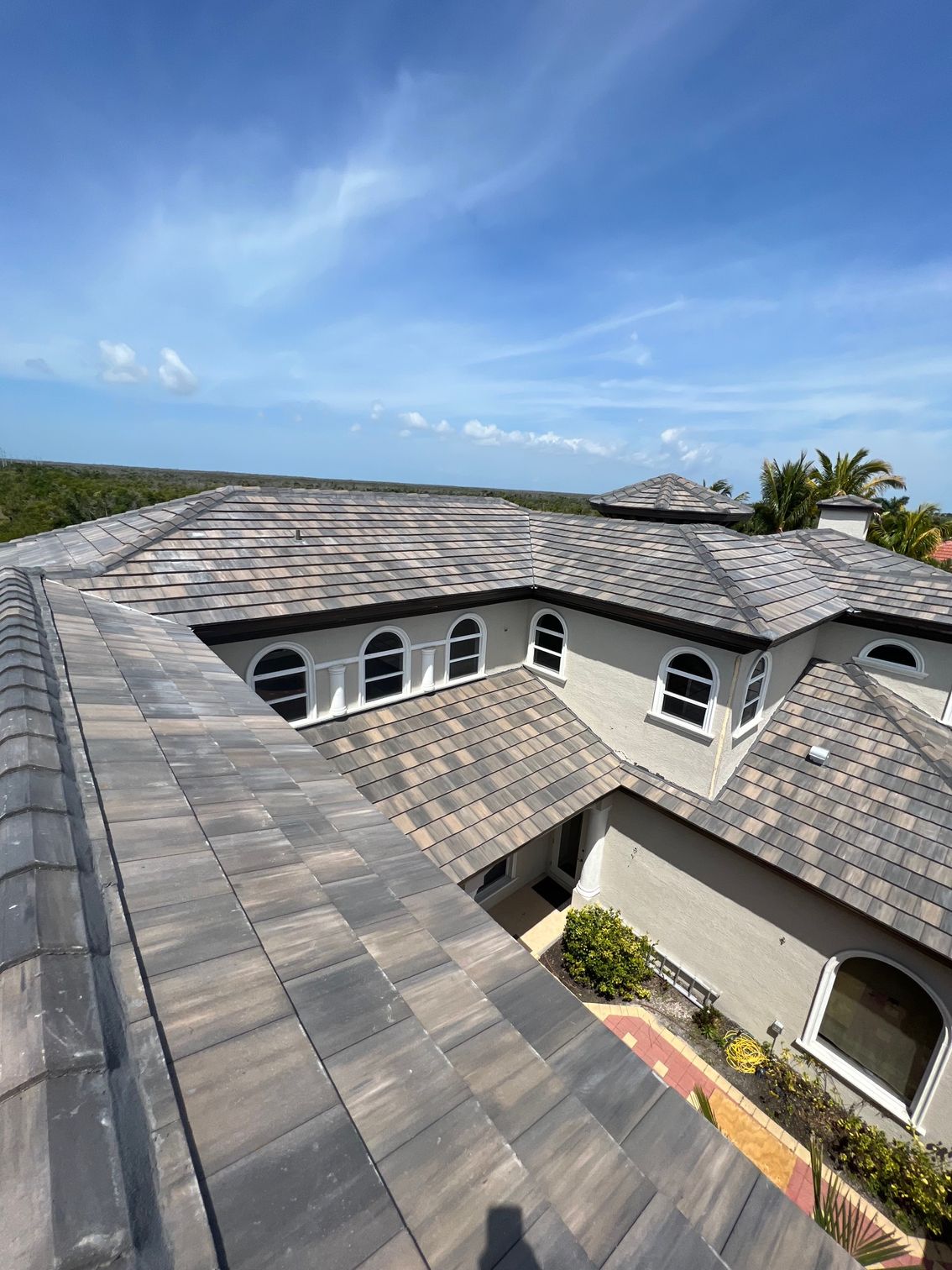 An aerial view of a large house with a tiled roof.
