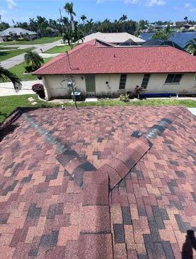 An aerial view of a house with a red roof.