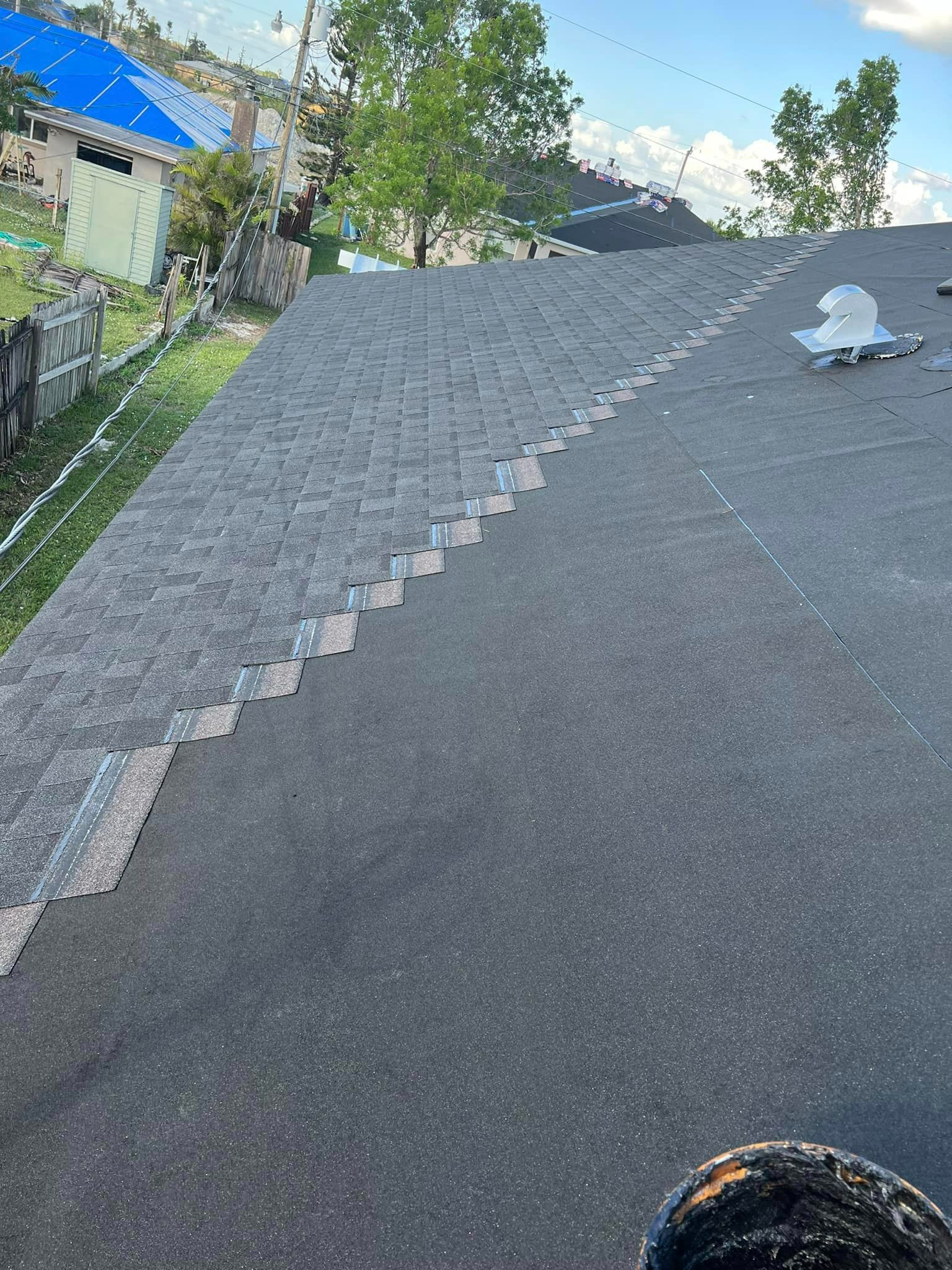 A person is standing on the roof of a house.