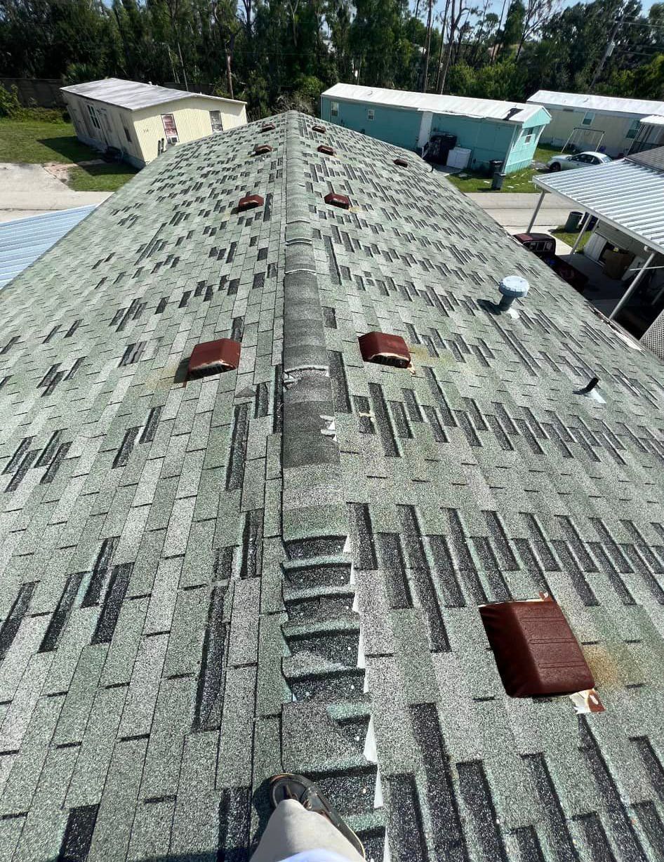 A person is standing on the roof of a house.