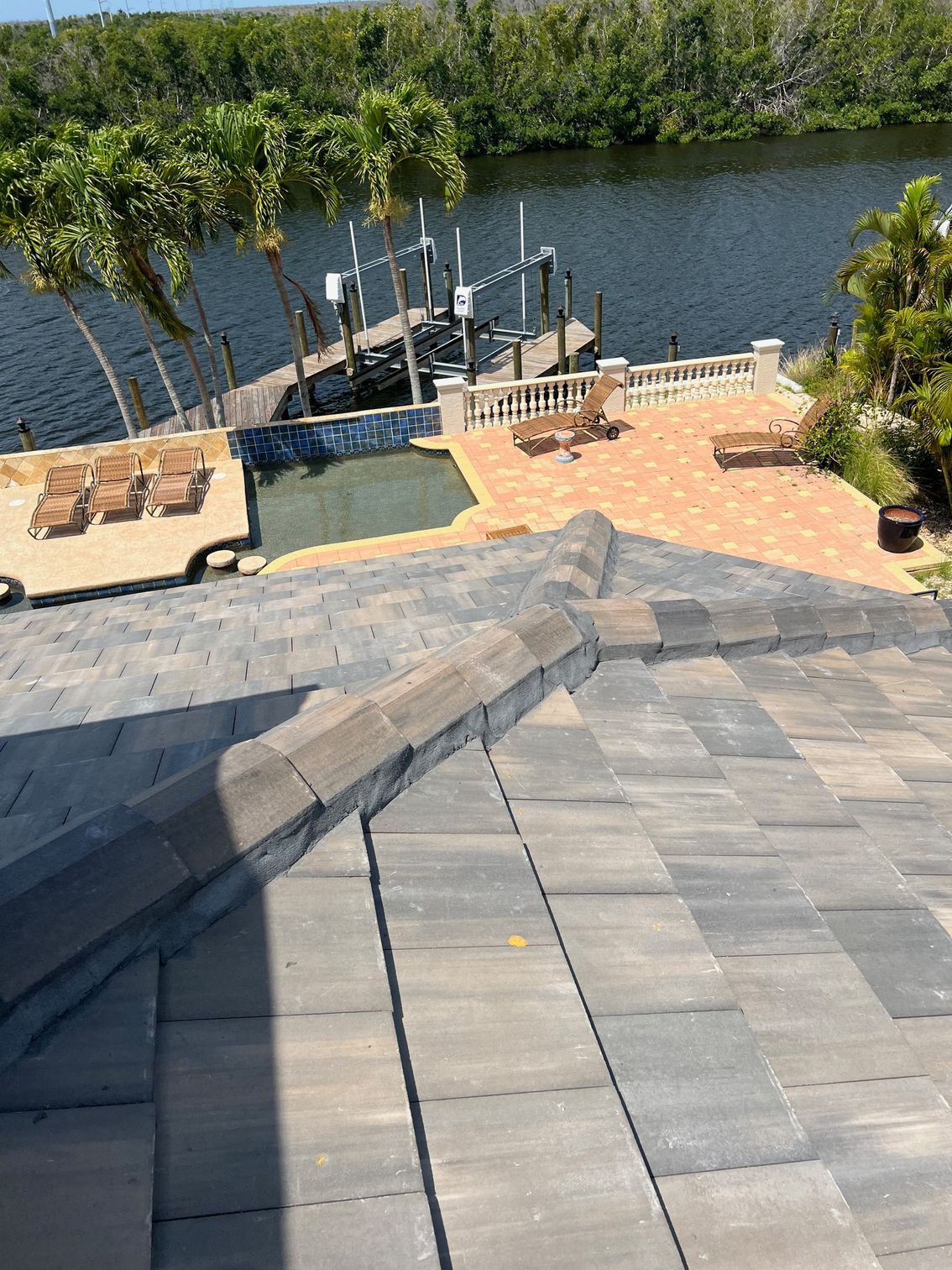 A view of a swimming pool from the roof of a house.