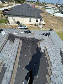An aerial view of a roof being installed on a house.