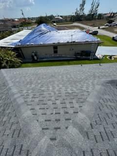 The roof of a house is covered with a tarp.