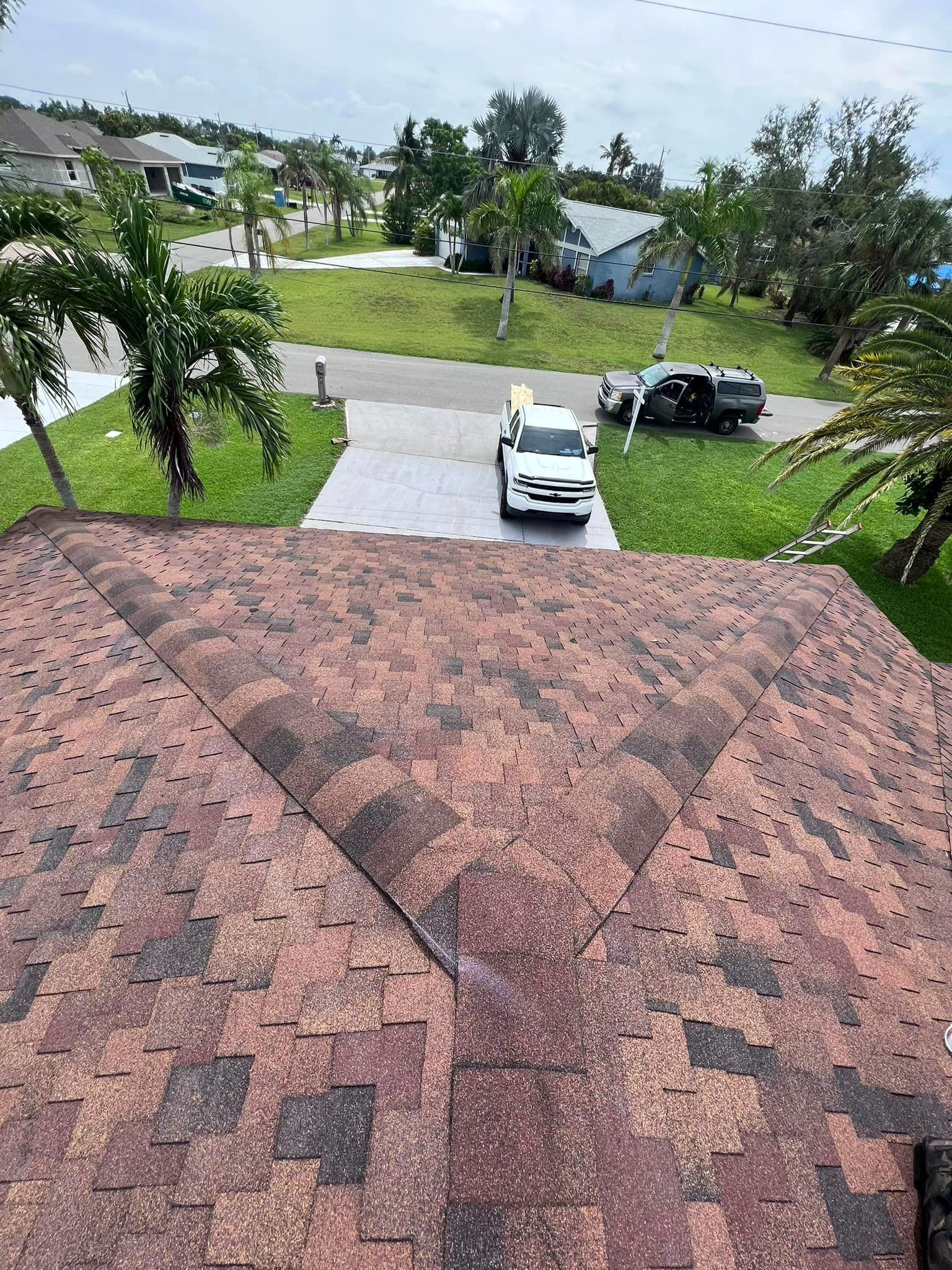 A white truck is parked on the roof of a house.