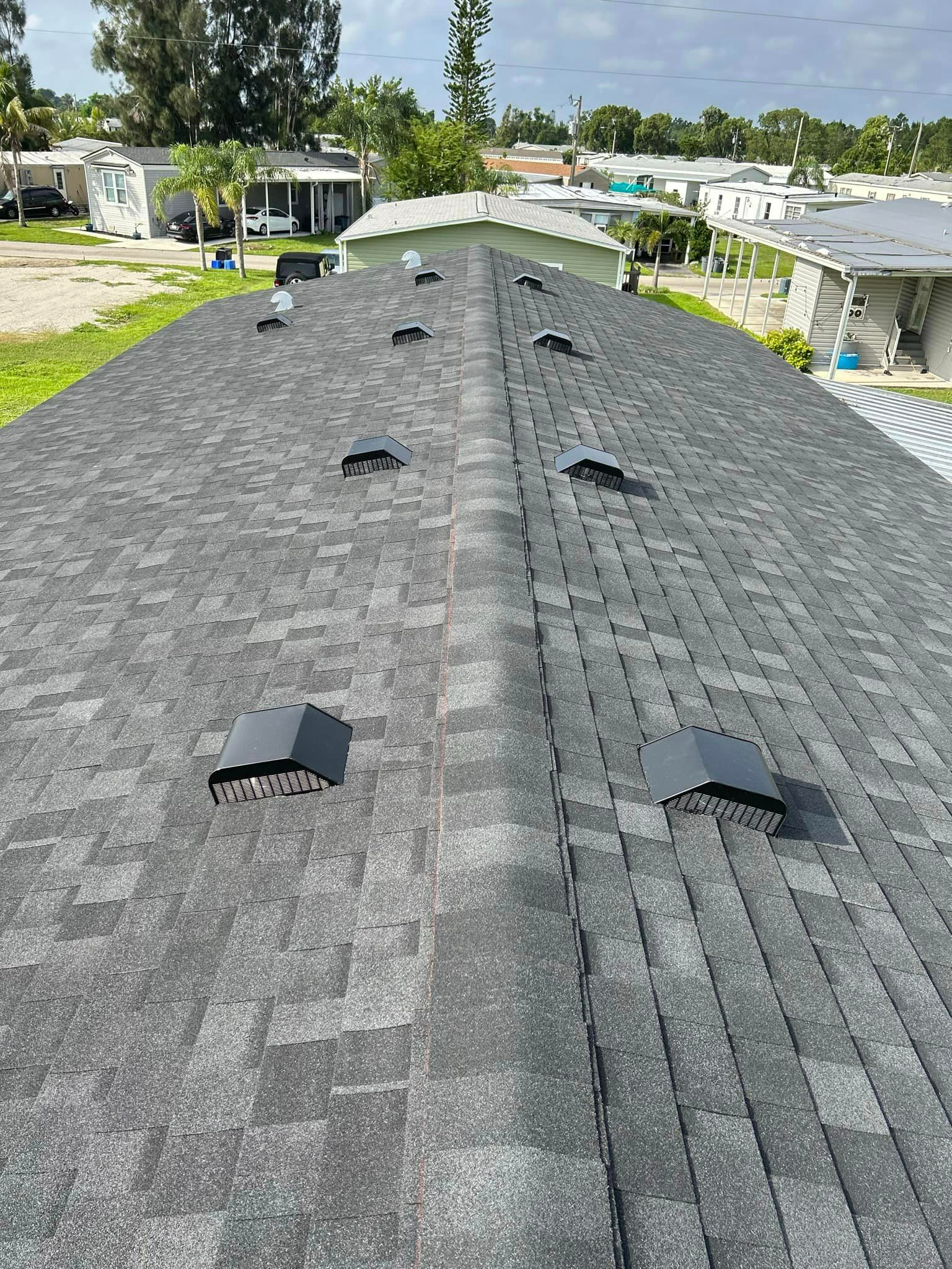 A close up of a roof with a lot of vents on it.