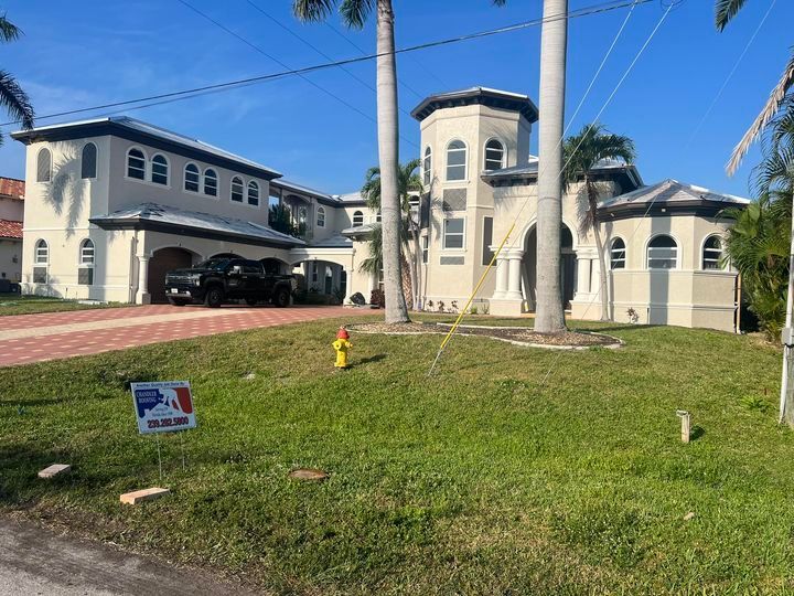 A large white house with a fire hydrant in front of it.