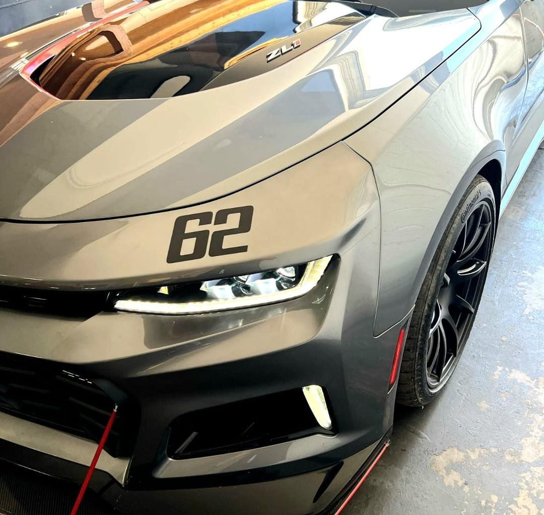 A car with the number 62 on the hood