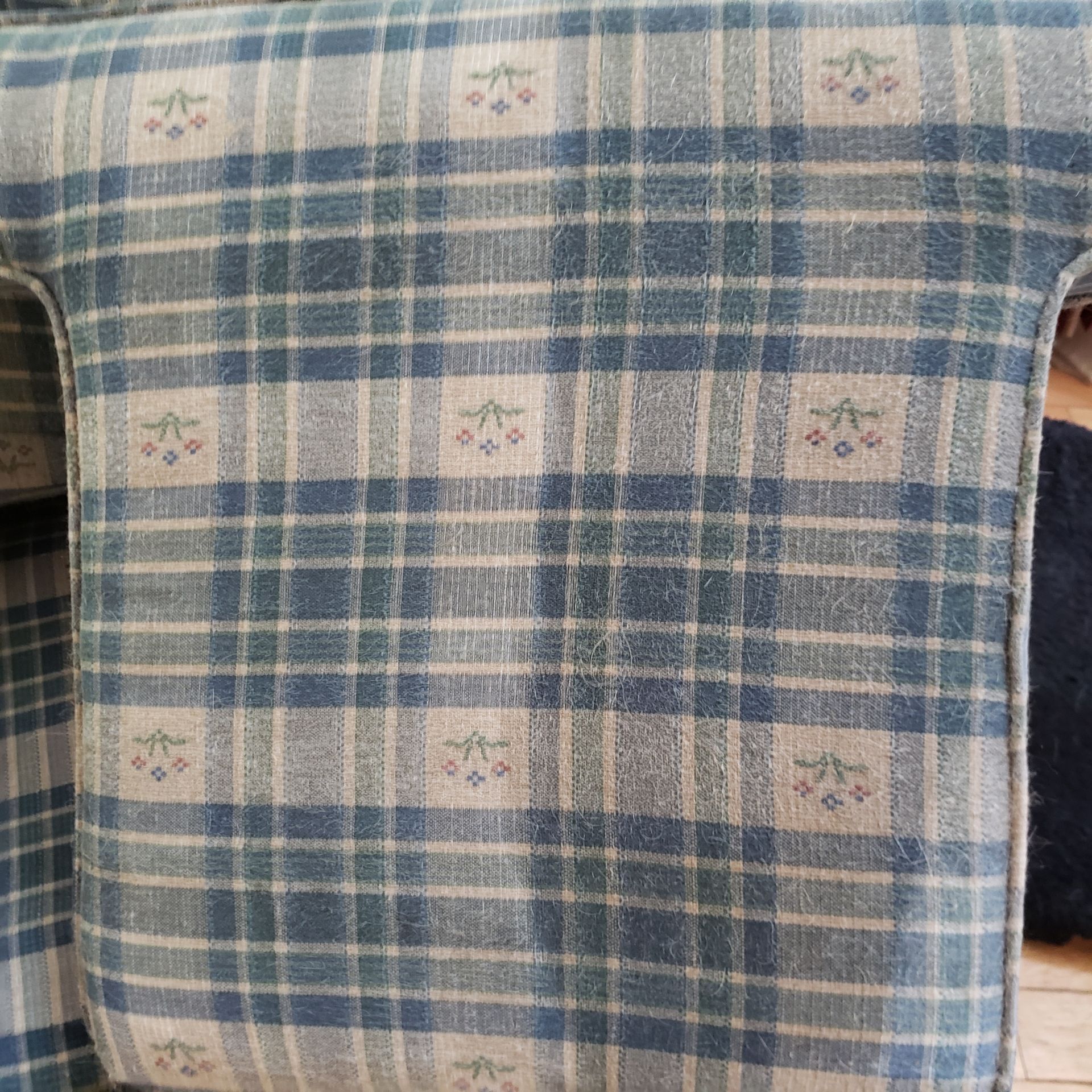a blue and white plaid blanket with flowers on it