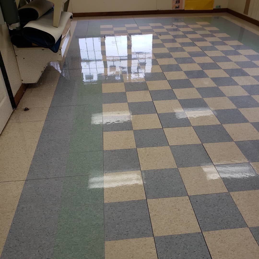 a room with a checkered floor and a chair in the corner