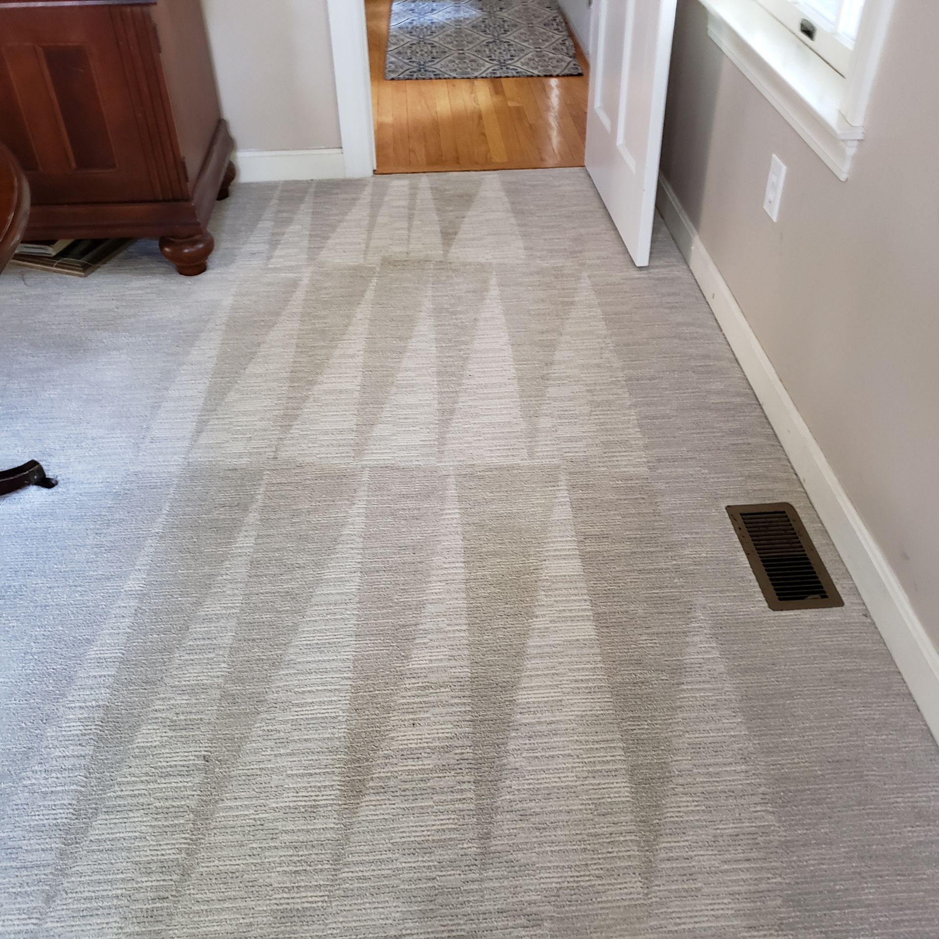 a room with a carpeted floor and a window