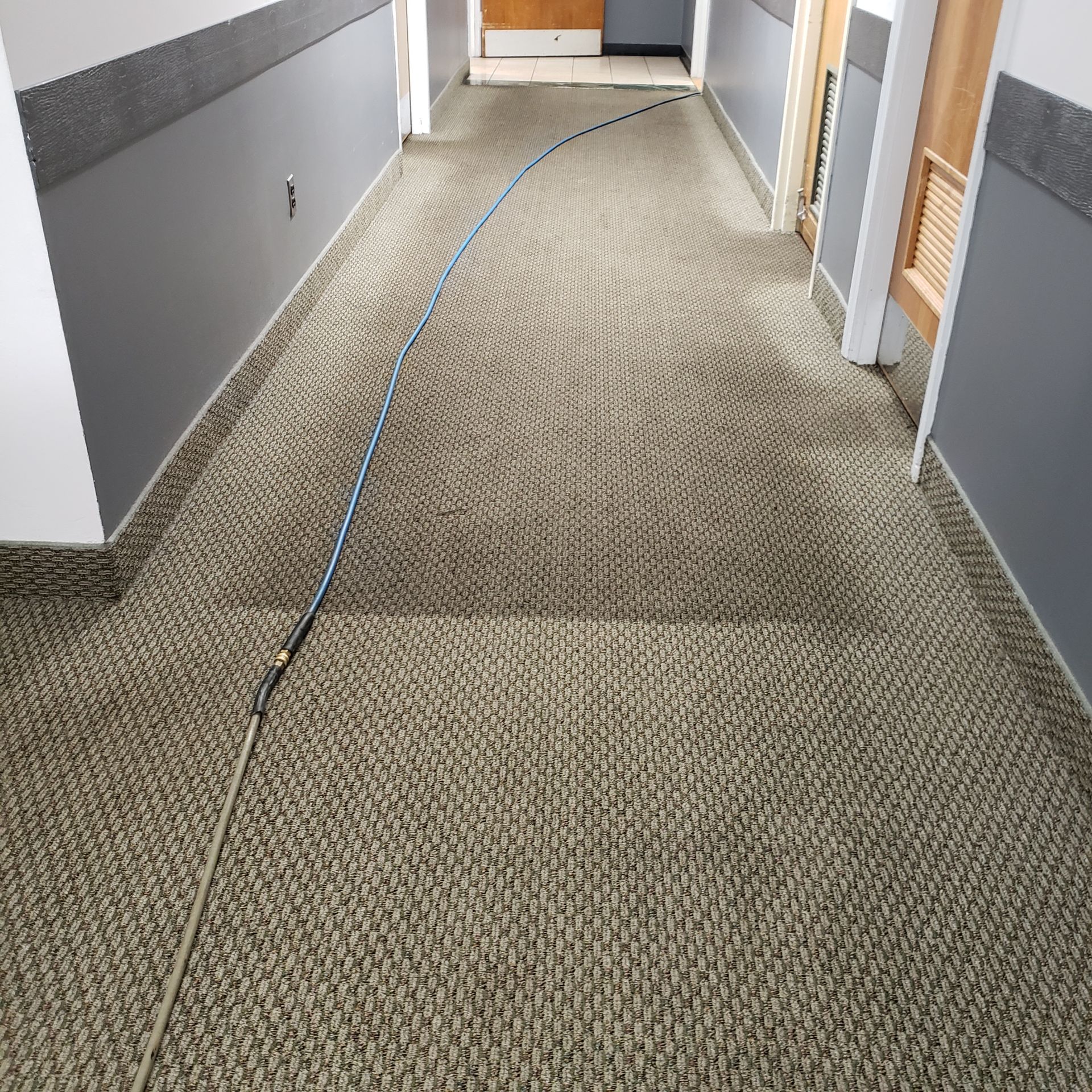 a long hallway with a hose going down it