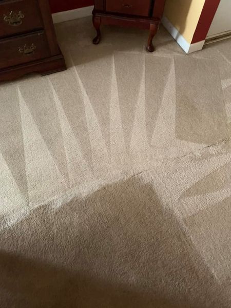 a close up of a carpet in a room with a nightstand
