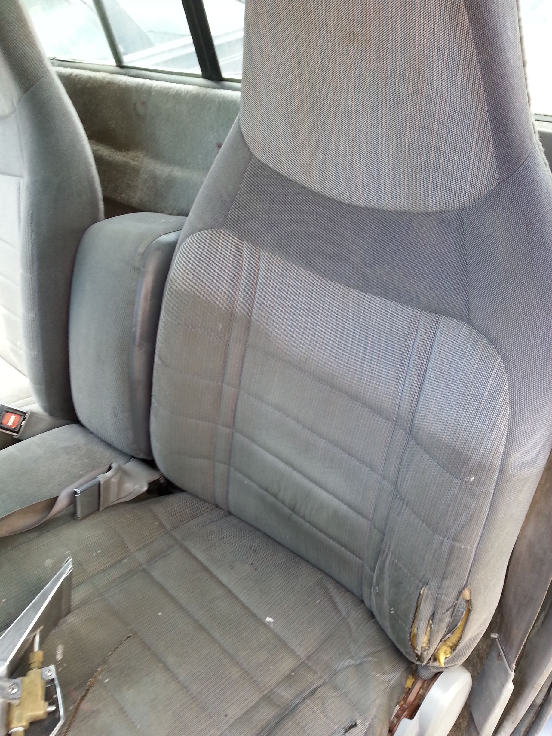 a close up of a car seat with a broken back rest