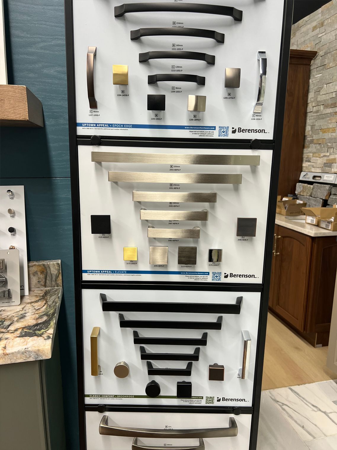 Cabinet hardware display with various knobs and pulls.