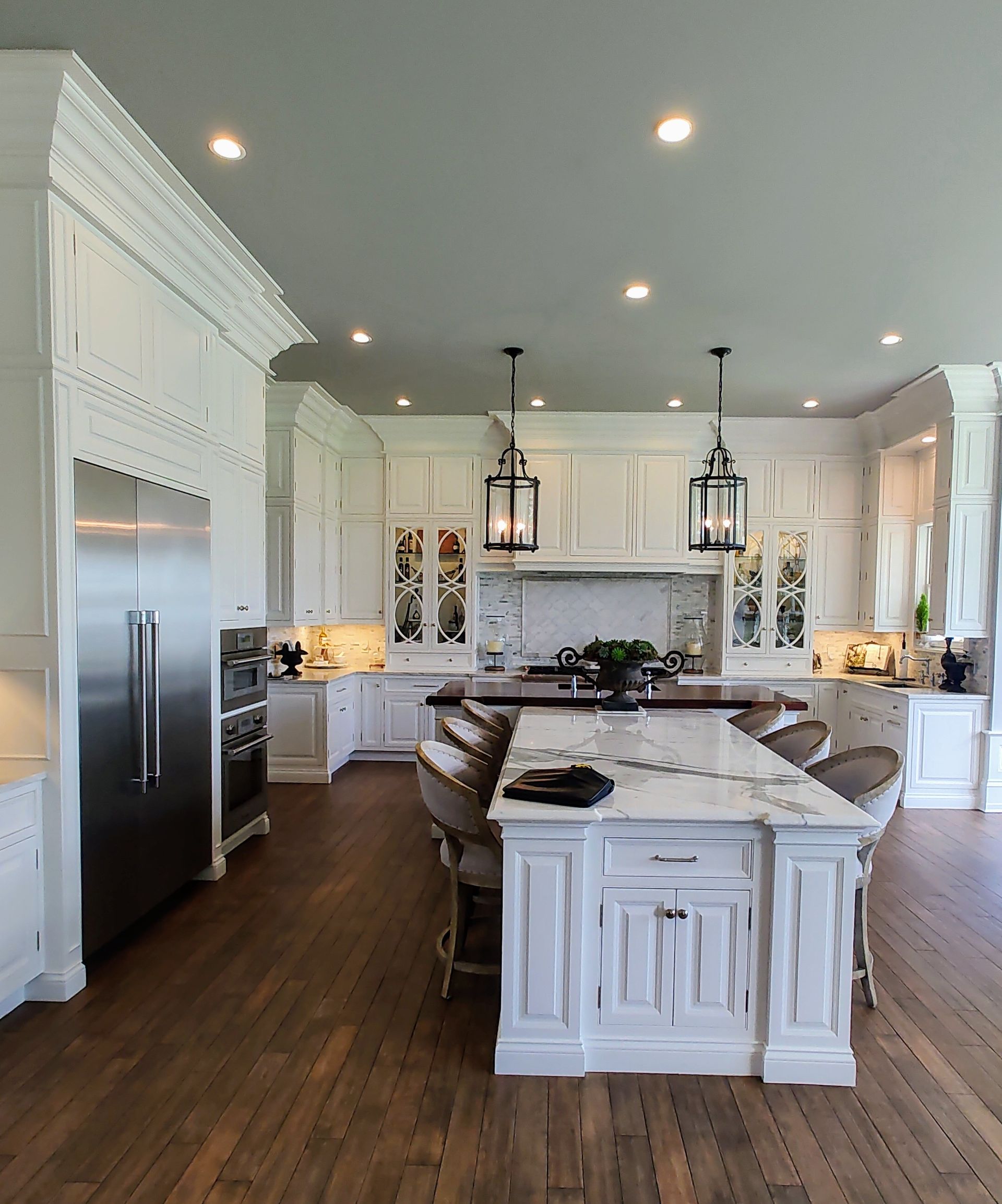 A kitchen with white cabinets and stainless steel appliances