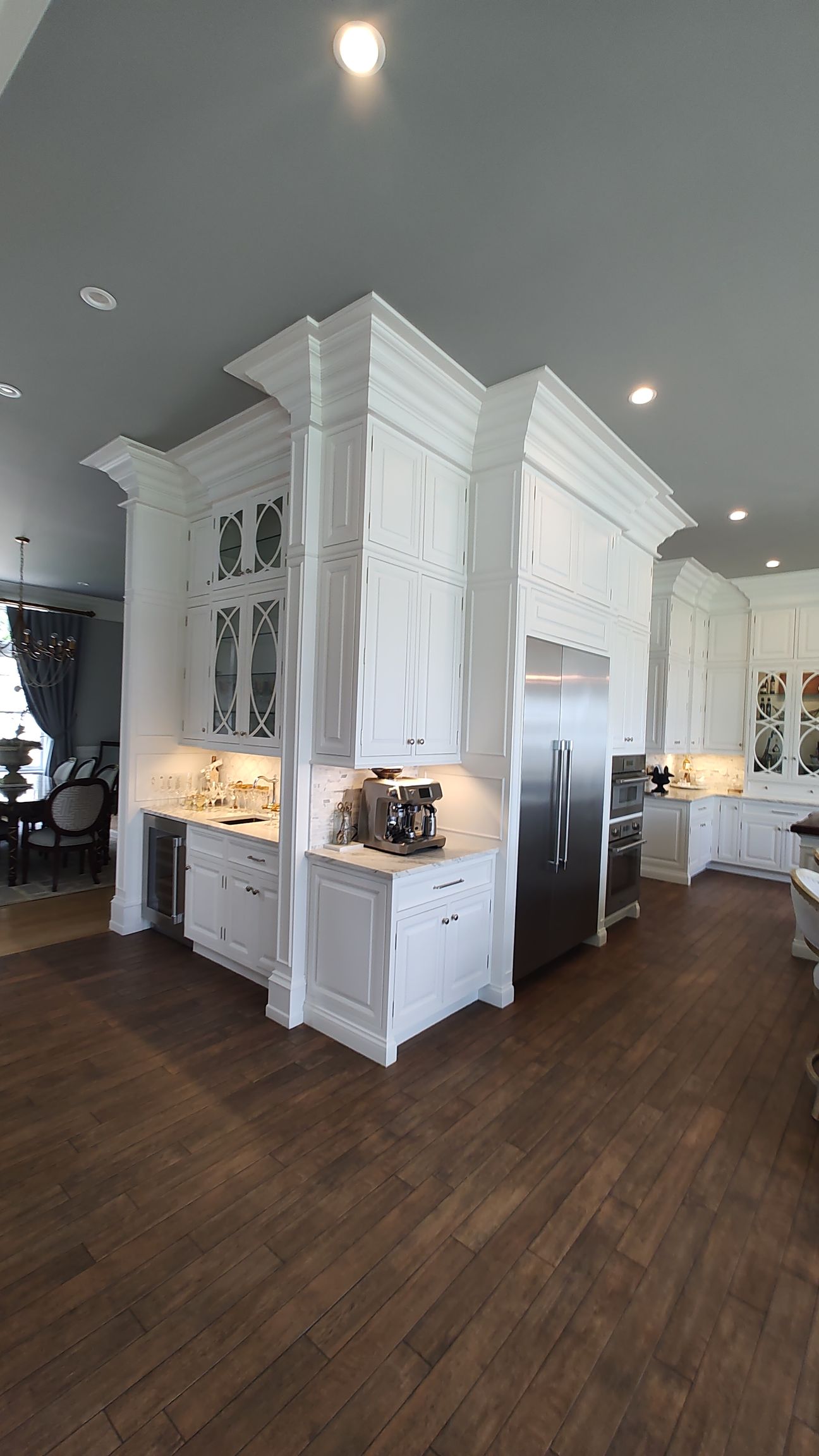 A large kitchen with white cabinets and stainless steel appliances.