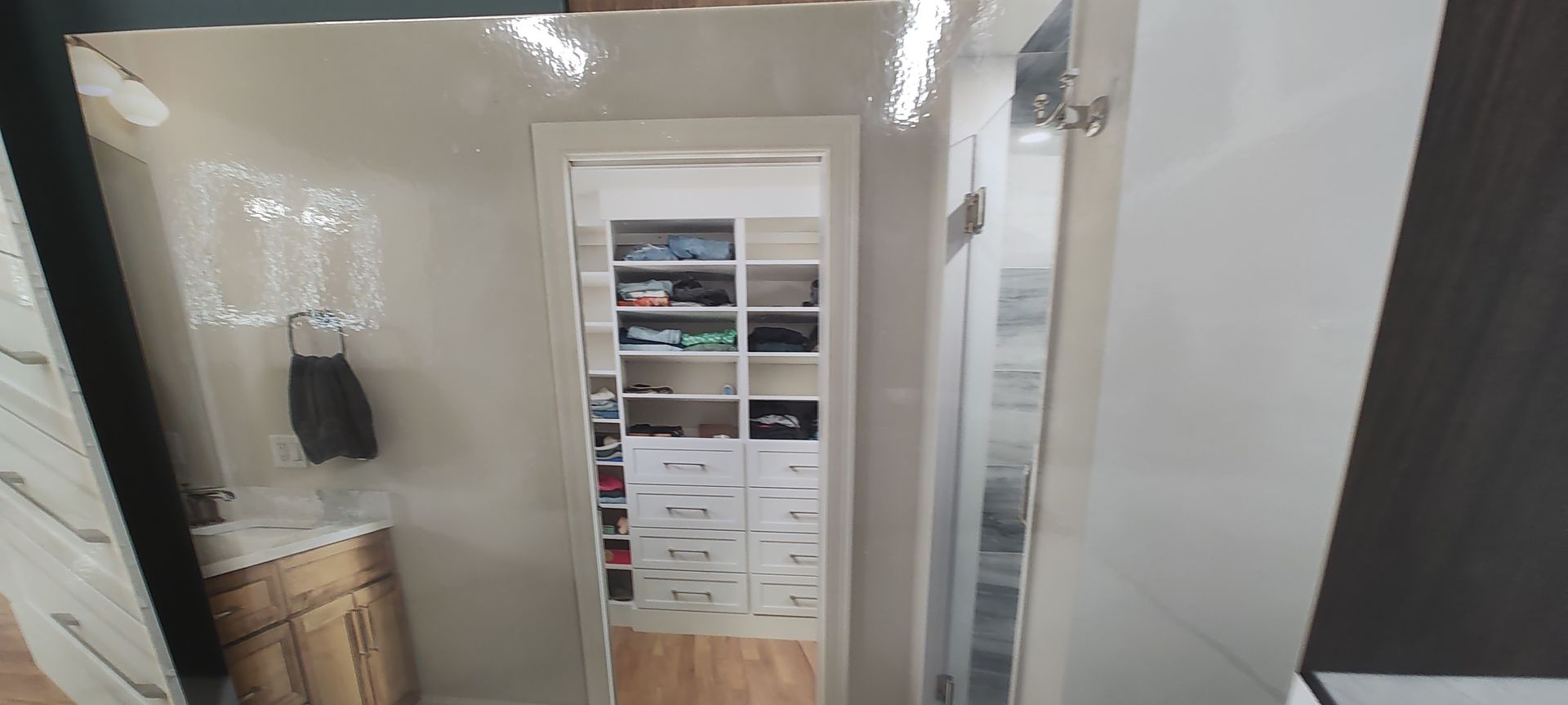 A picture of a closet with lots of shelves and a door.