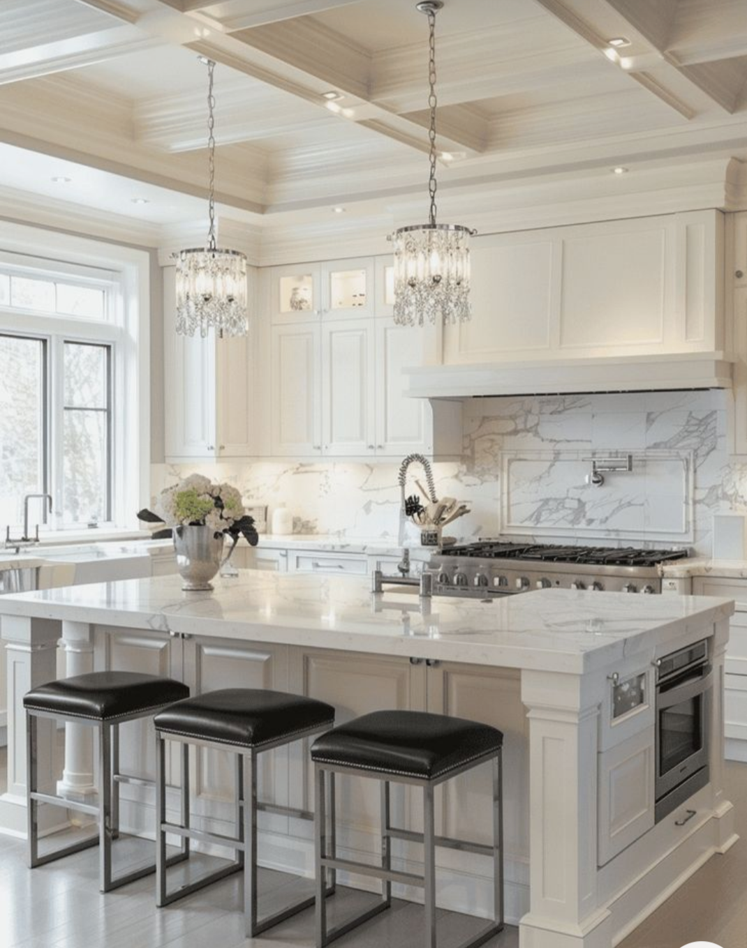 A kitchen with white cabinets and black stools