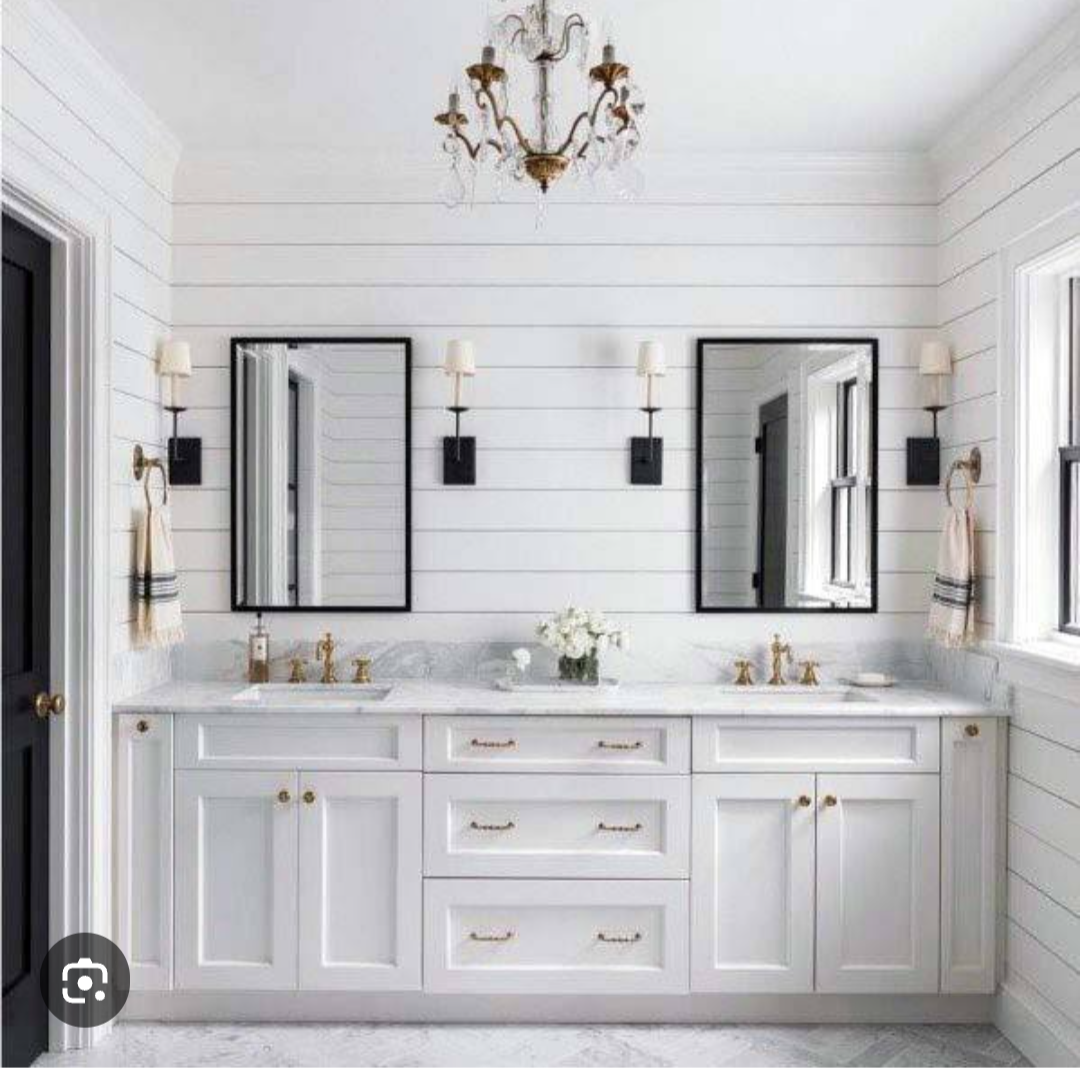 A bathroom with two sinks and two mirrors