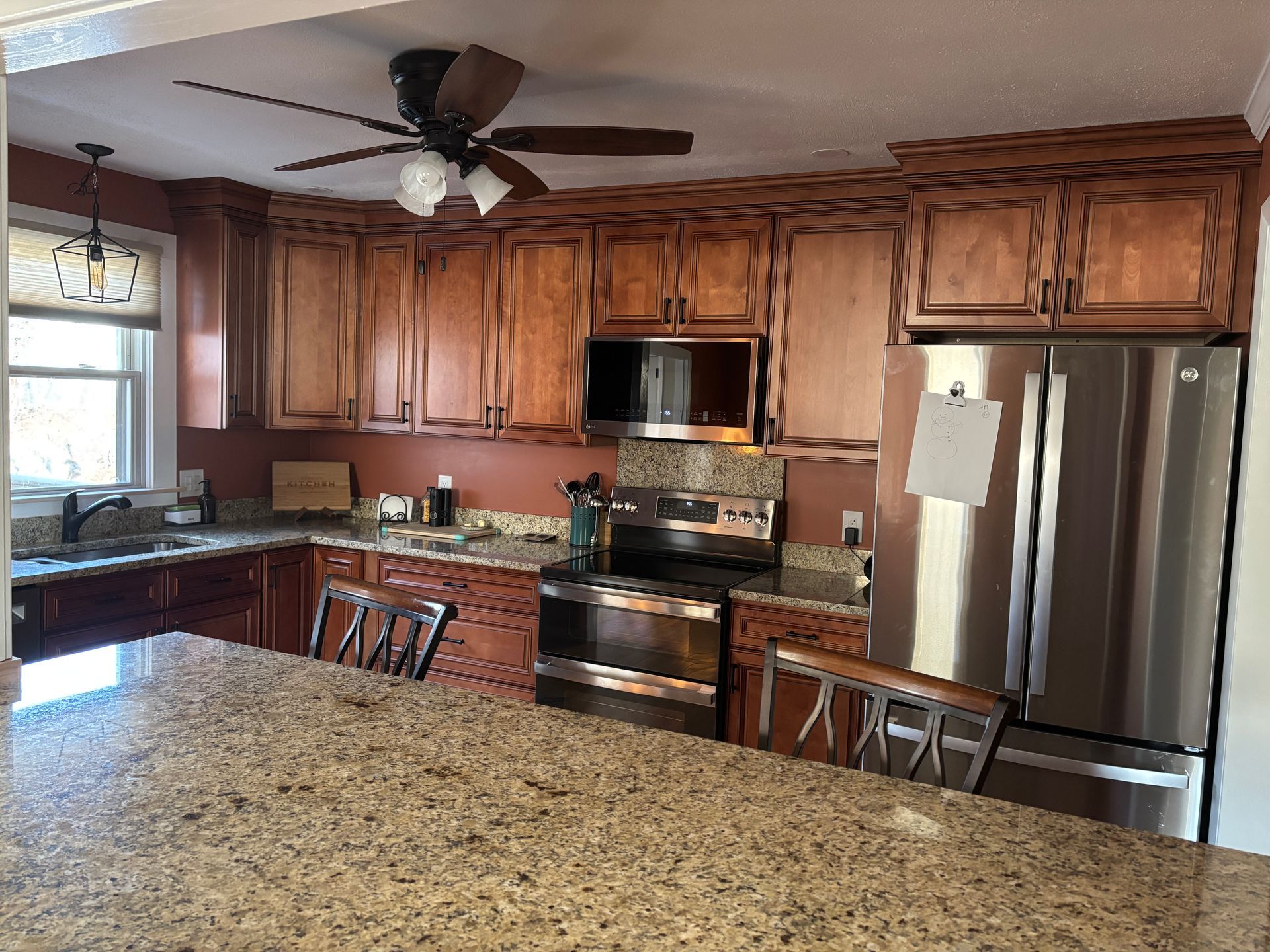 A kitchen with stainless steel appliances and granite countertops