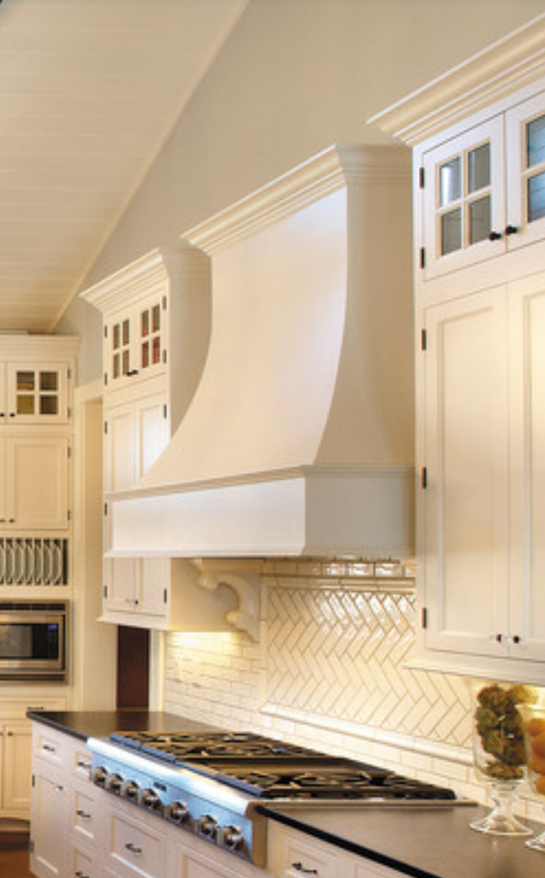 A kitchen with white cabinets and a stove top oven