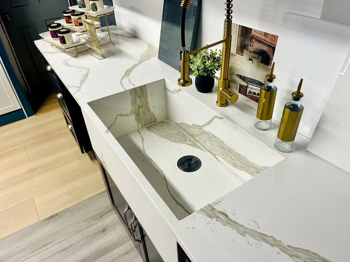 A kitchen sink with a faucet and soap dispensers on the counter