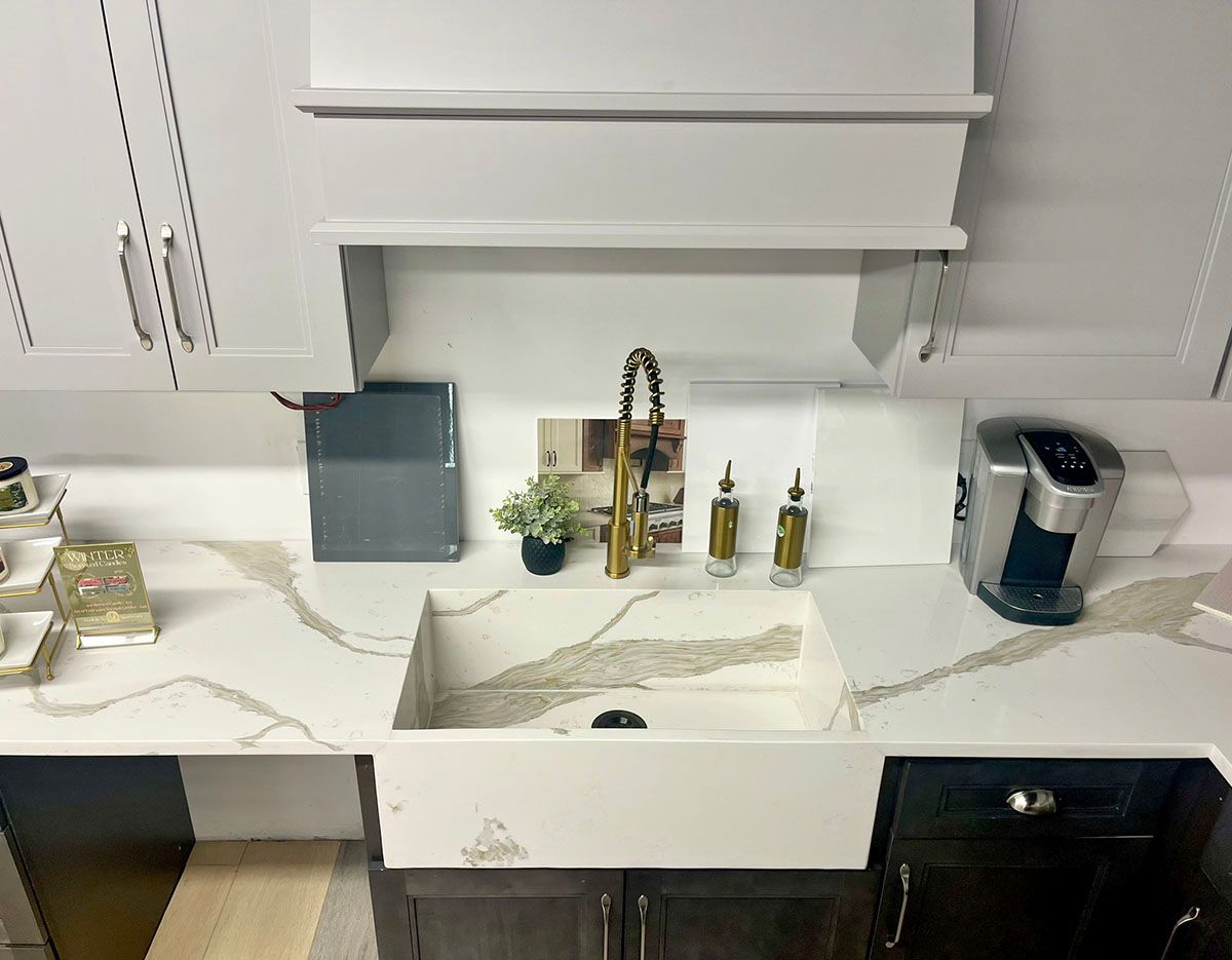 A kitchen with a sink and a coffee maker on the counter