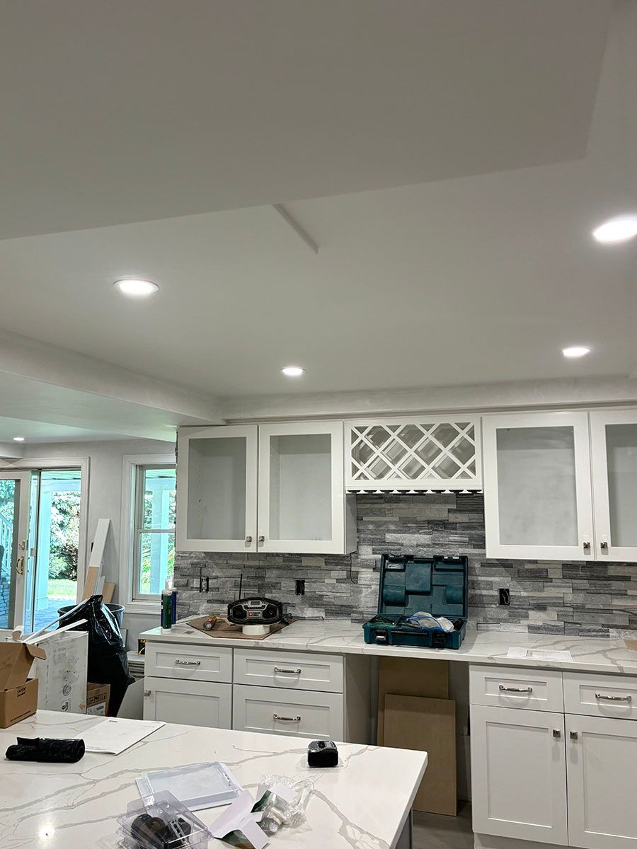 A newly remodeled kitchen with white cabinets and granite counter top