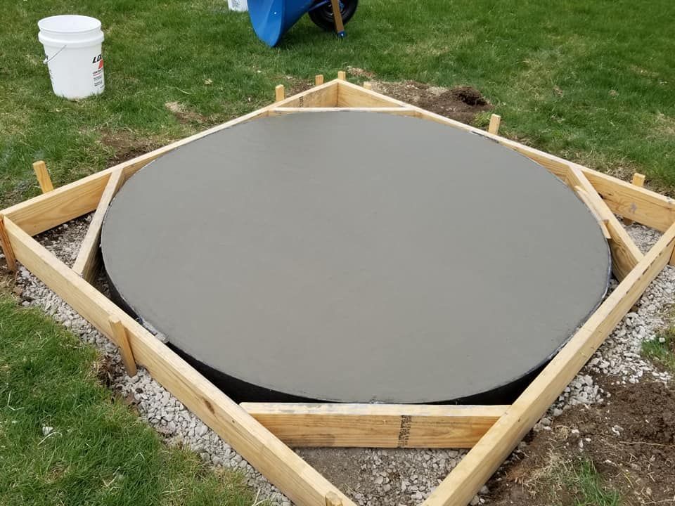 A concrete circle is being built in a wooden frame.