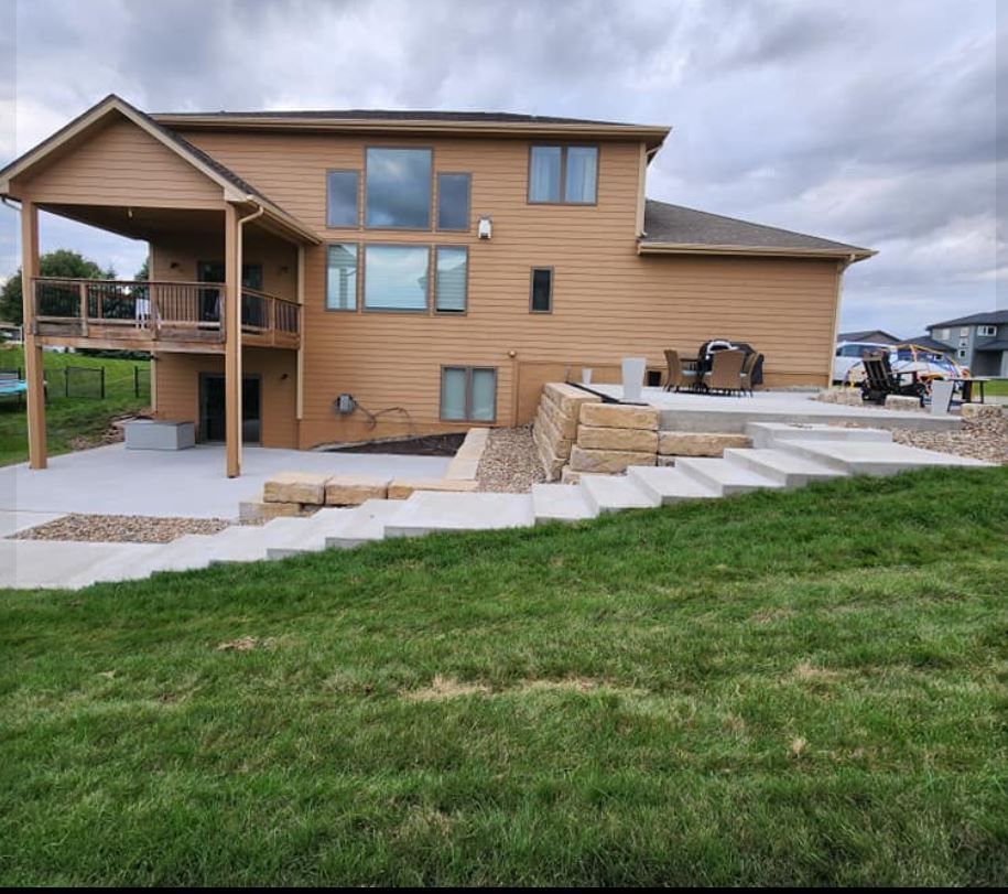 A large house with stairs leading up to it