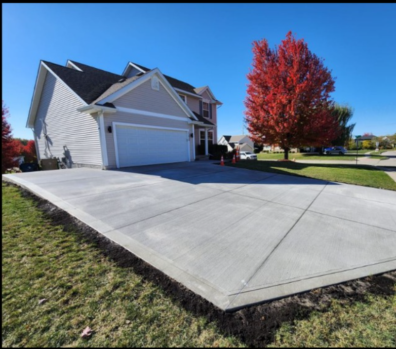 A large house with a concrete driveway in front of it.