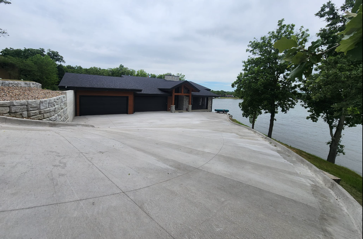A large house sits next to a body of water
