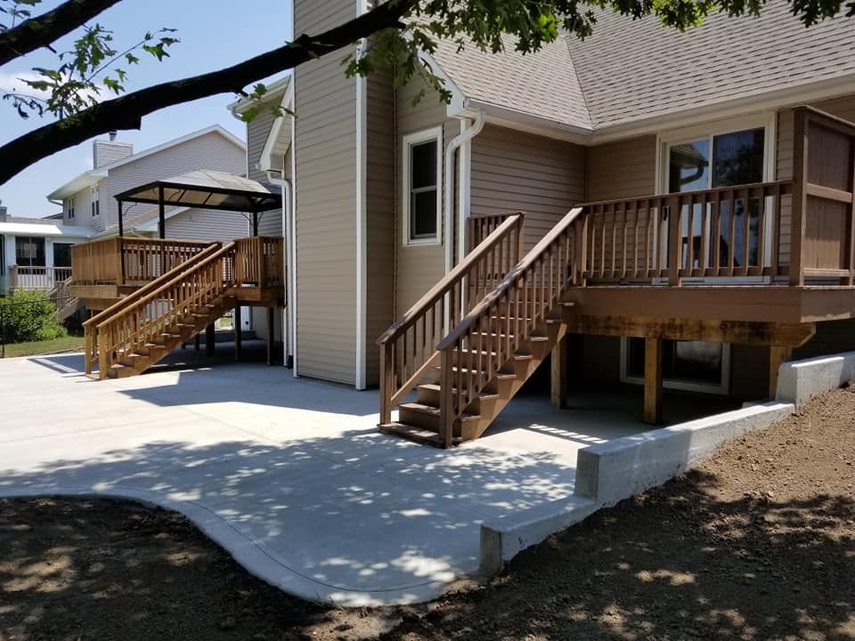 A house with a deck and stairs leading up to it