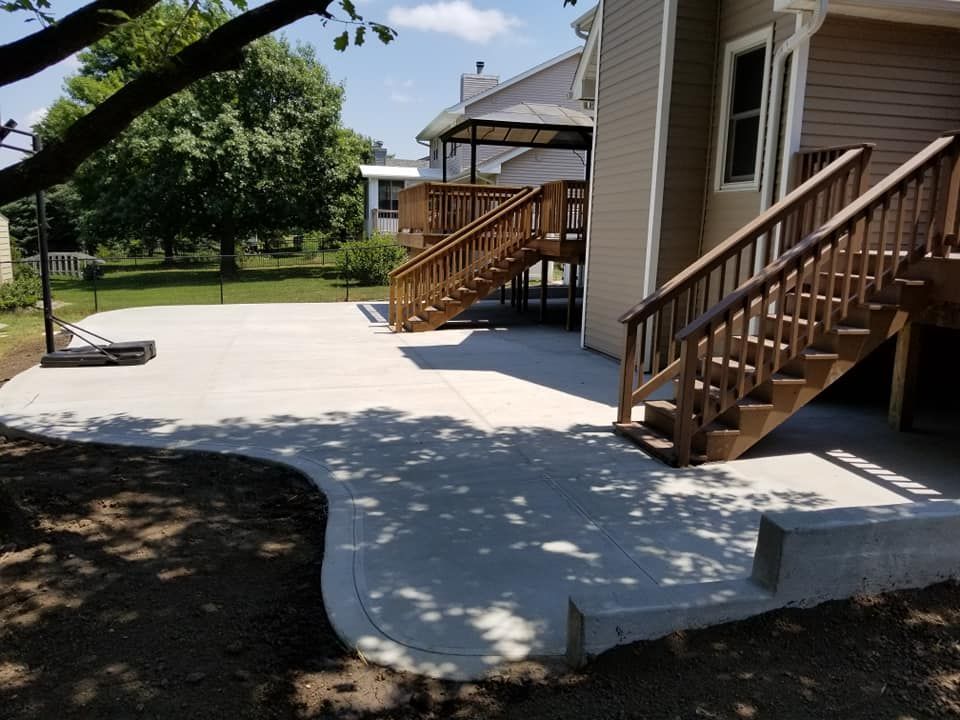 A house with a deck and stairs in the backyard