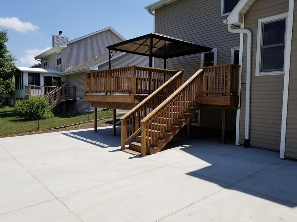A wooden deck with stairs leading up to it