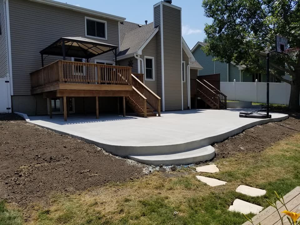 A house with a deck and a patio in front of it