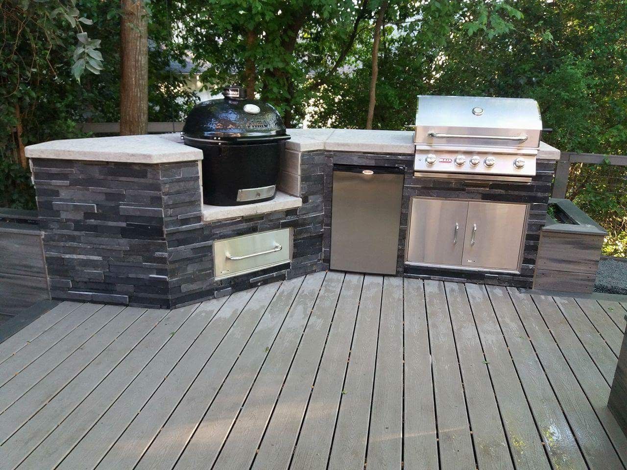 A wooden deck with a grill and a dishwasher on it