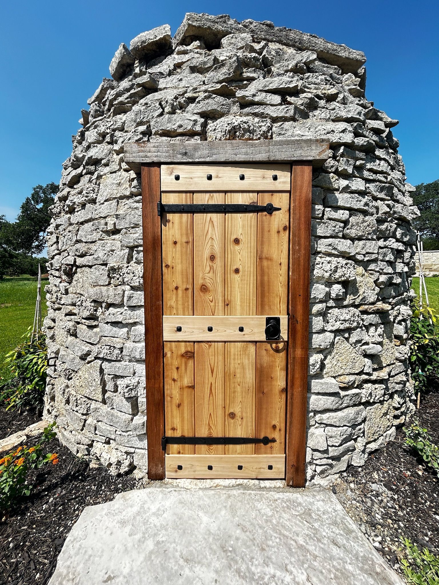 A stone building with a wooden door in front of it