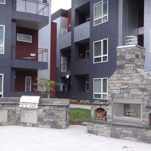 A building with a grill and a fireplace in front of it