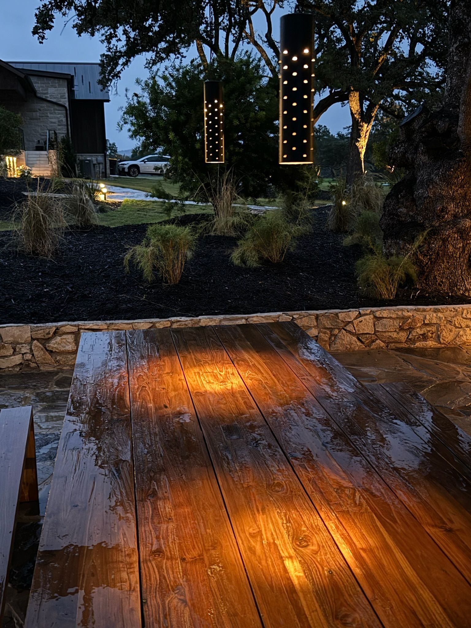 A wooden deck with a few lights on it